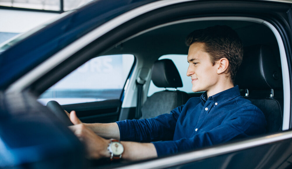 young-man-looking-car-rent